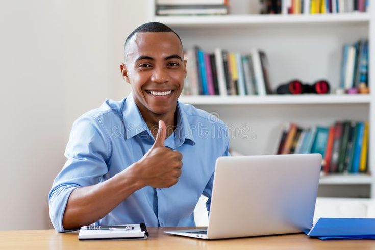 Successful african american man at computer_ At…